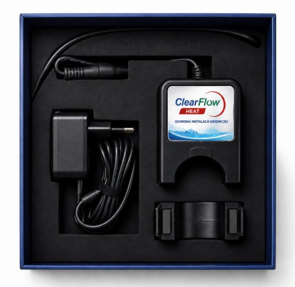 Blue presentation box containing a ClearFlow Heat heating module with its power adapter, cables, and mounting strap in foam inserts (informational product shot).